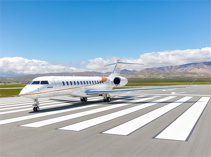A white, 19-seat twin-engine Bombardier Global 7500 business jet parked on a runway.