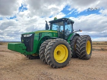 2014 John Deere 8335R tractor parked on dirt.