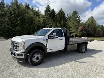 A 2024 Ford FF50 flatbed work truck parked on a lot.