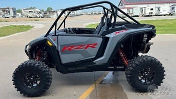 A 2025 Polaris RZR XP 1000 premium side by side parked outdoors.