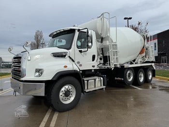 A 2025 Freightliner 114SD Mixer Truck sits on a lot.
