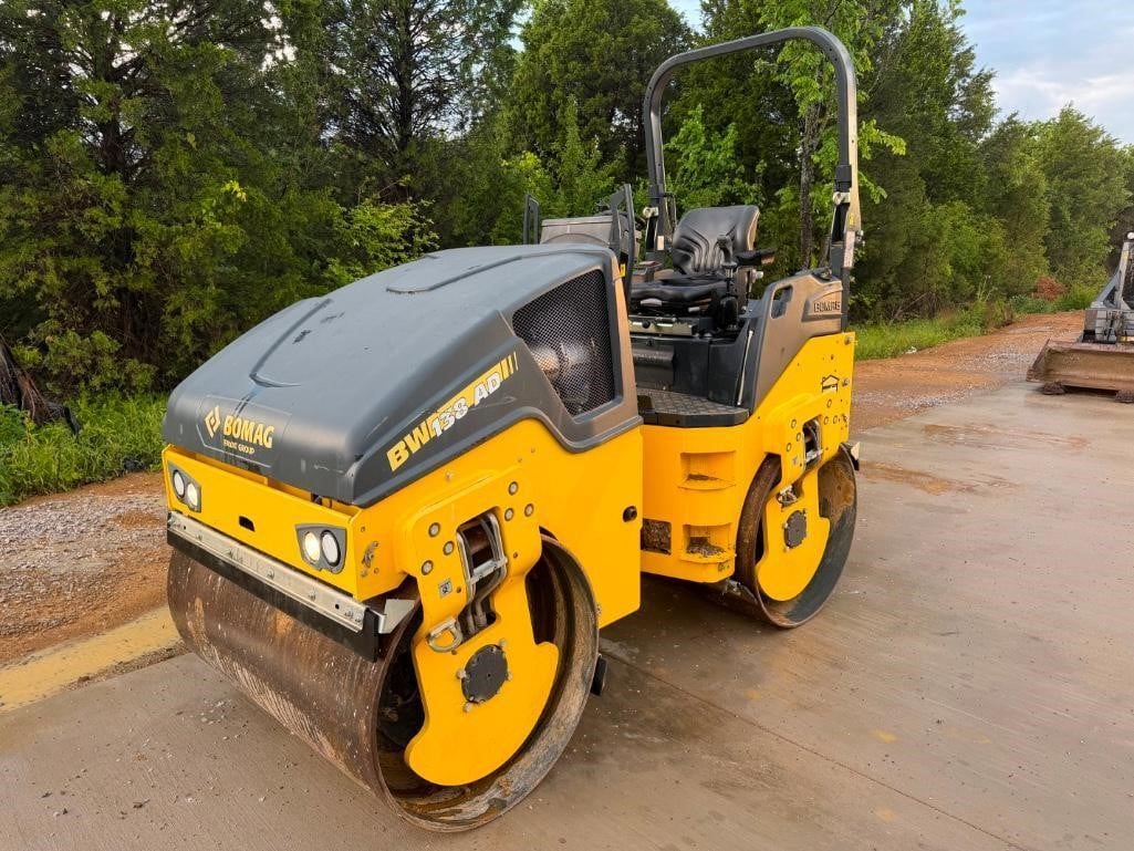 A 2021 Bomag BW138AD-5 smooth drum compactor parked outdoors.