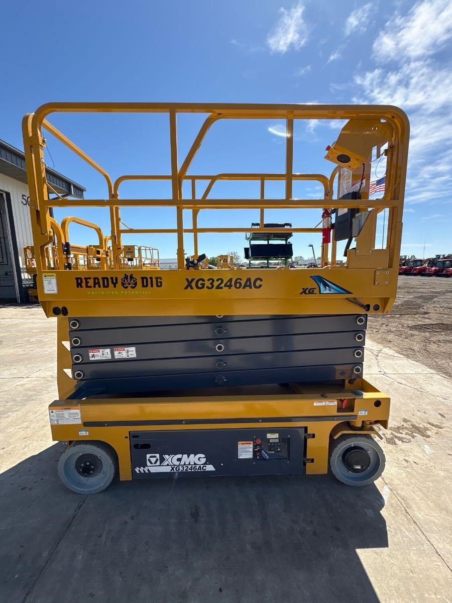 A 2023 XCMG XG3246AC Slab Scissor Lift sits outside a building.