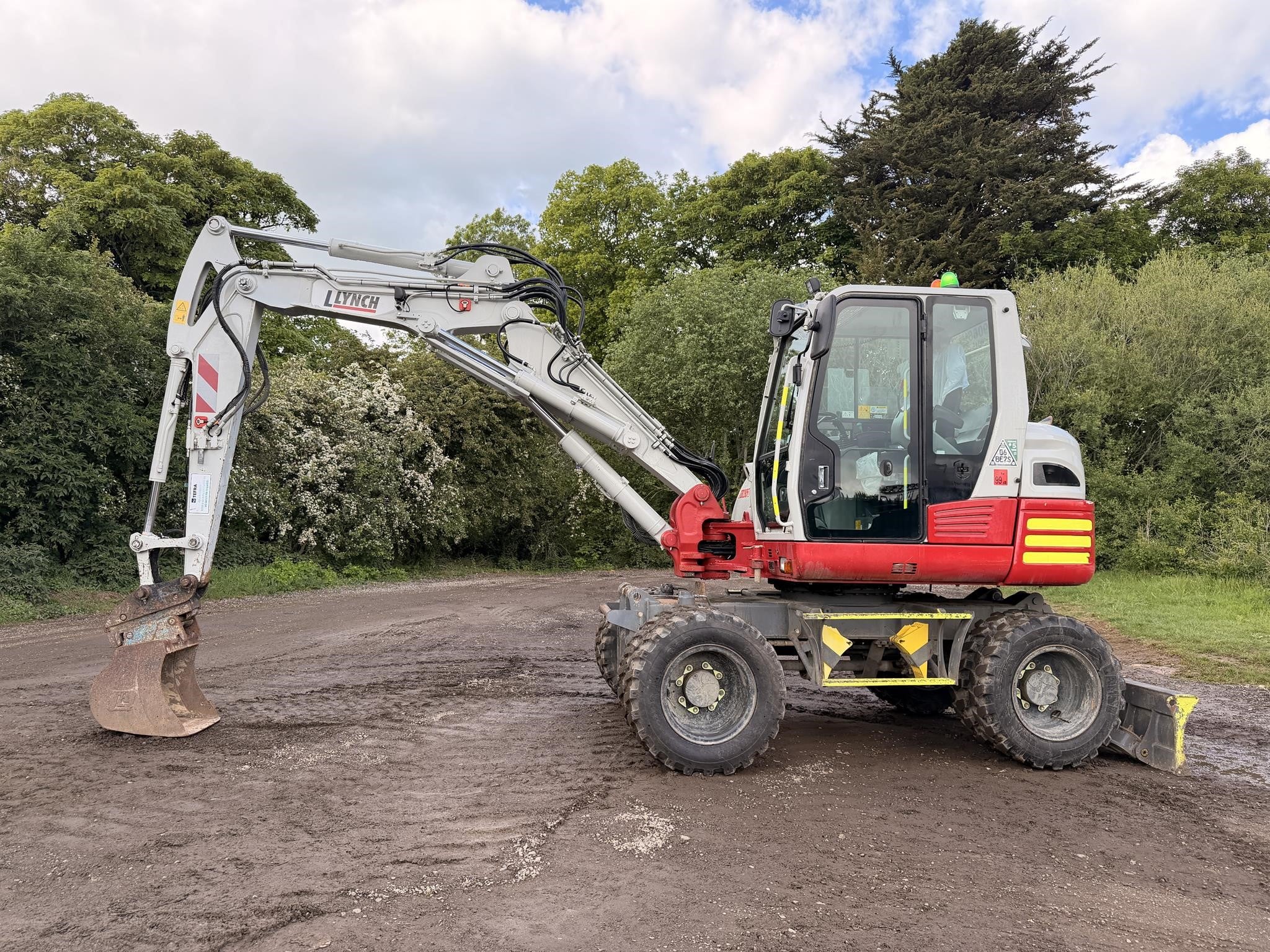 2022 Takeuchi TB295W Wheel Excavator parked outdoors.