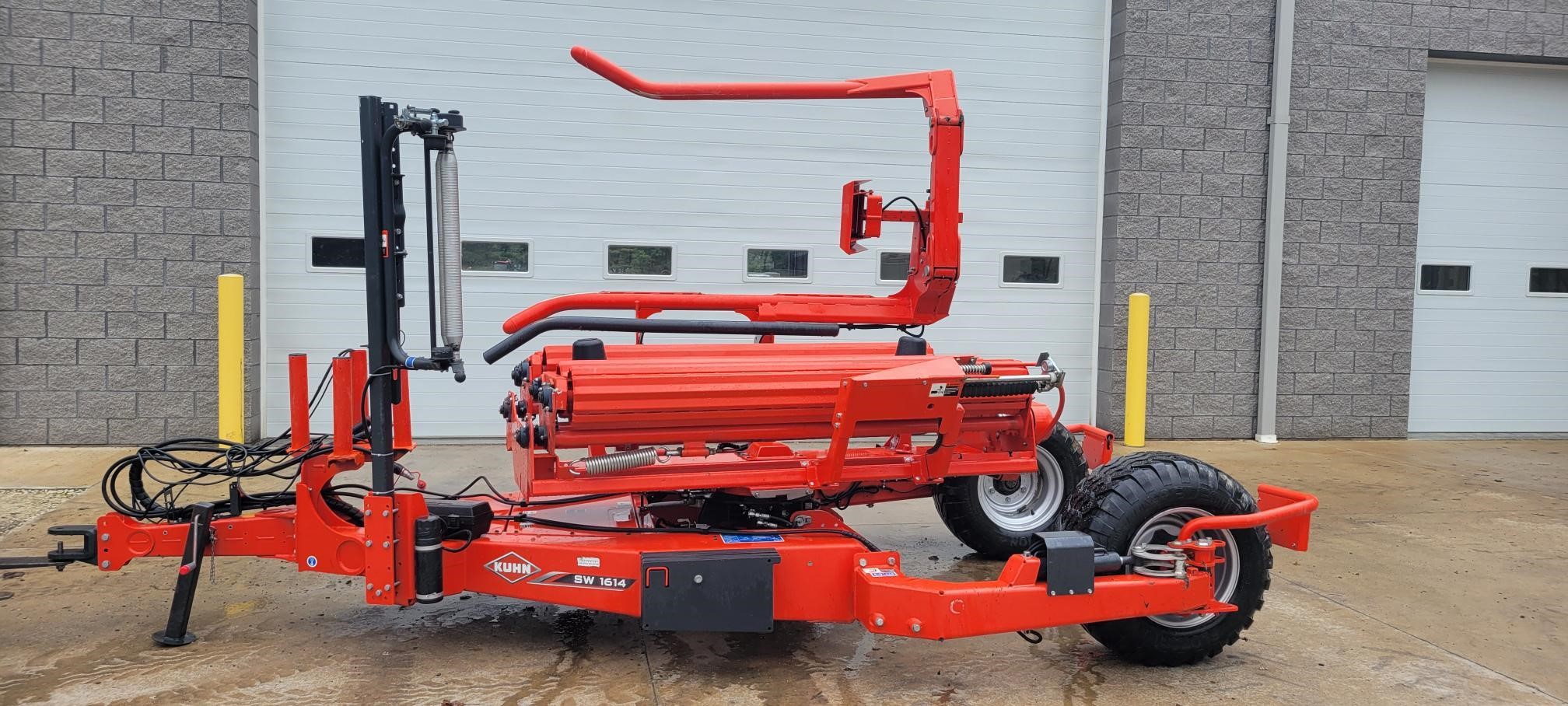 Orange 2021 Kuhn SW1614C bale wrapper parked outdoors.