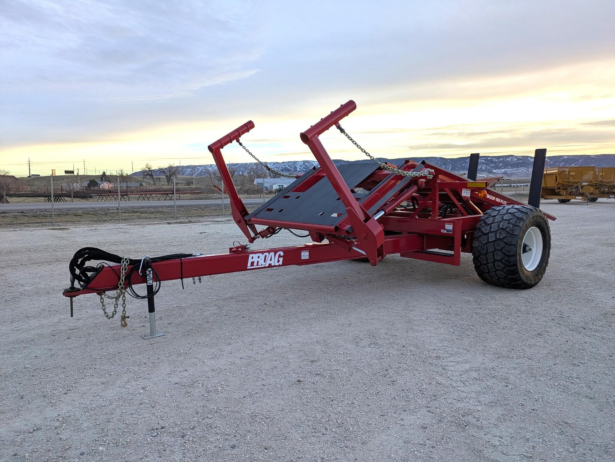 Red 2023 ProAG 4SR PLUS bale accumulator parked outdoors.