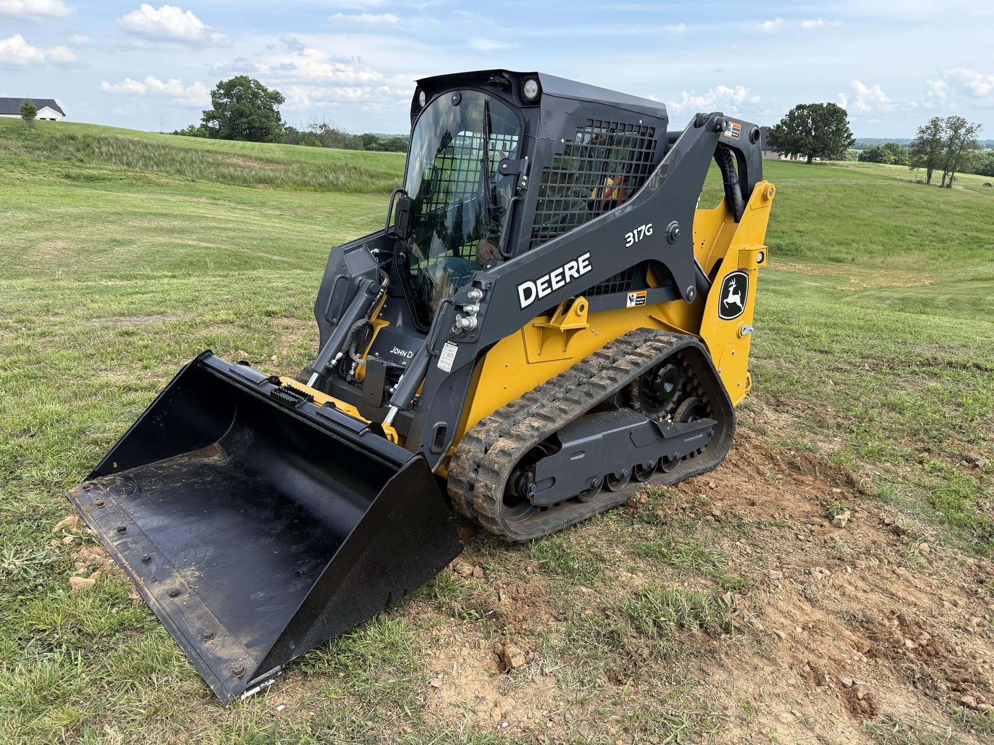 A 2023 Deere 317G track skid steer.
