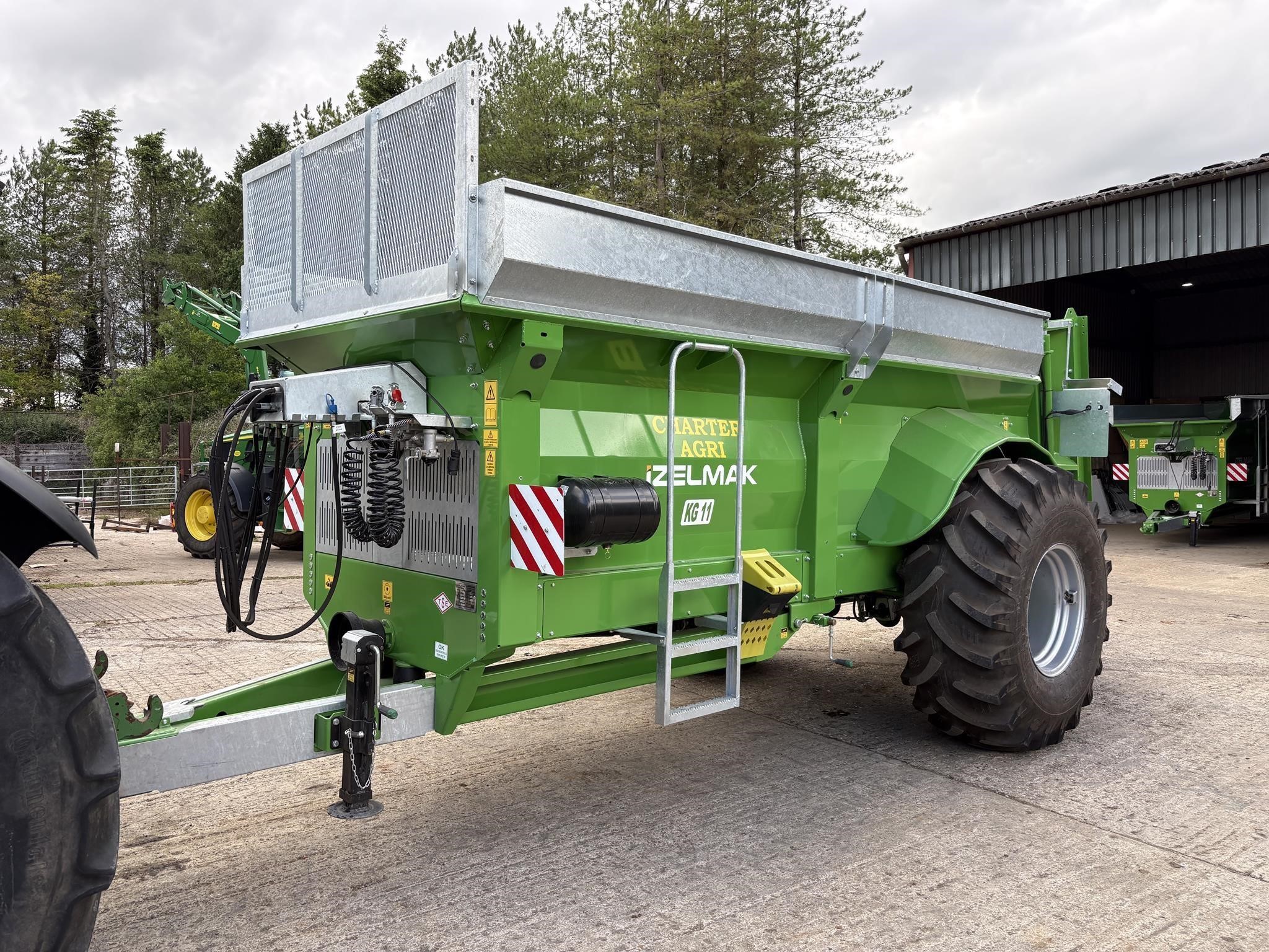 2026 Izelmak KG11 Dry Manure Spreader parked outdoors.