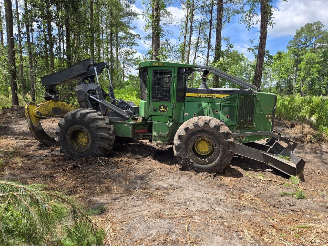 2023 Deere 748L skidder parked in a forest outdoors.