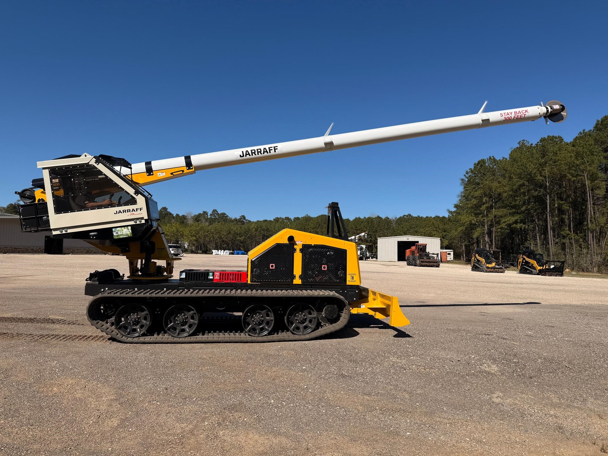 A 2026 Jarraff Rubber Track Tree Trimmer parked outdoors.