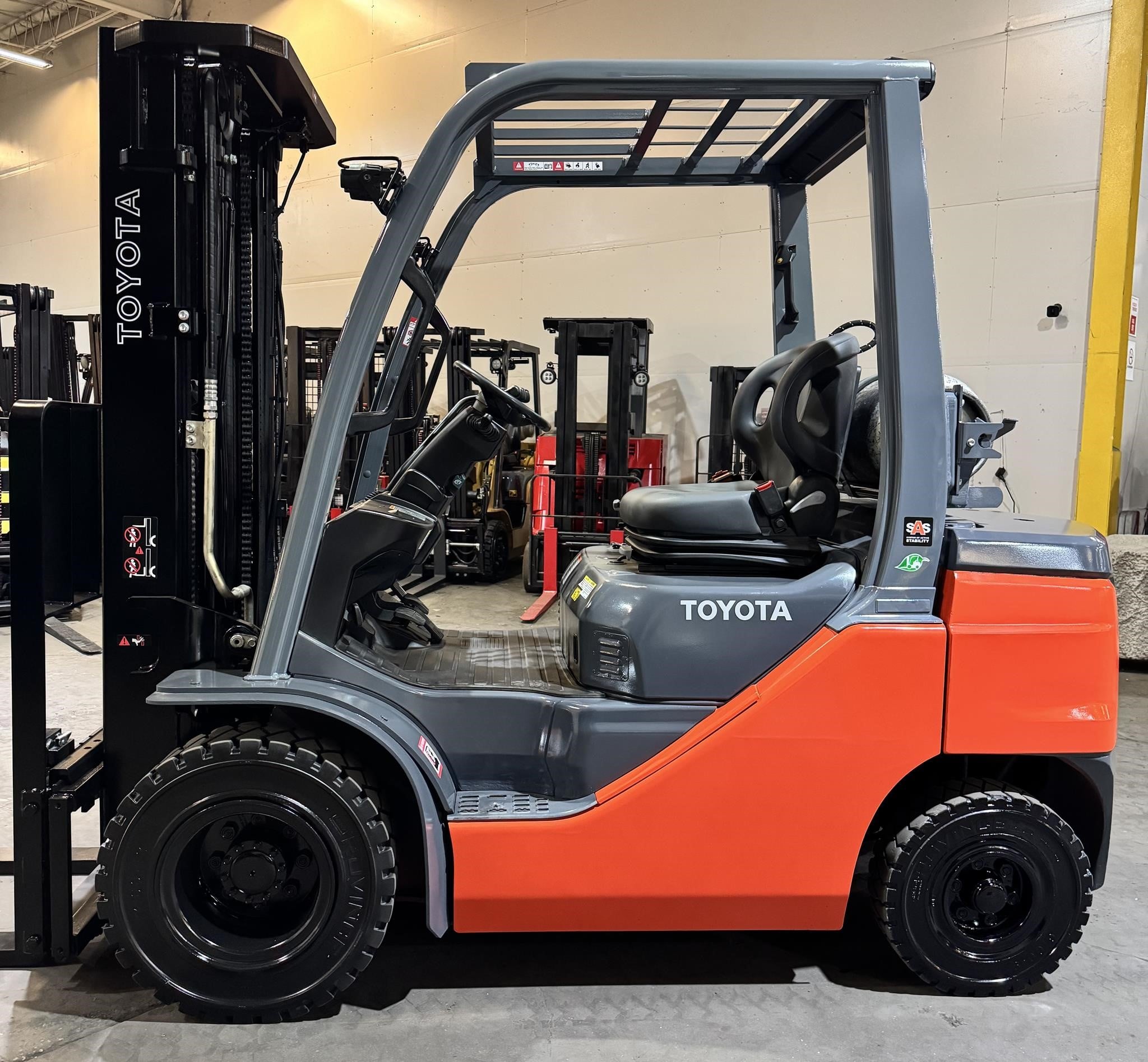 A 2023 Toyota 8FGU25 pneumatic-tire forklift parked indoors.