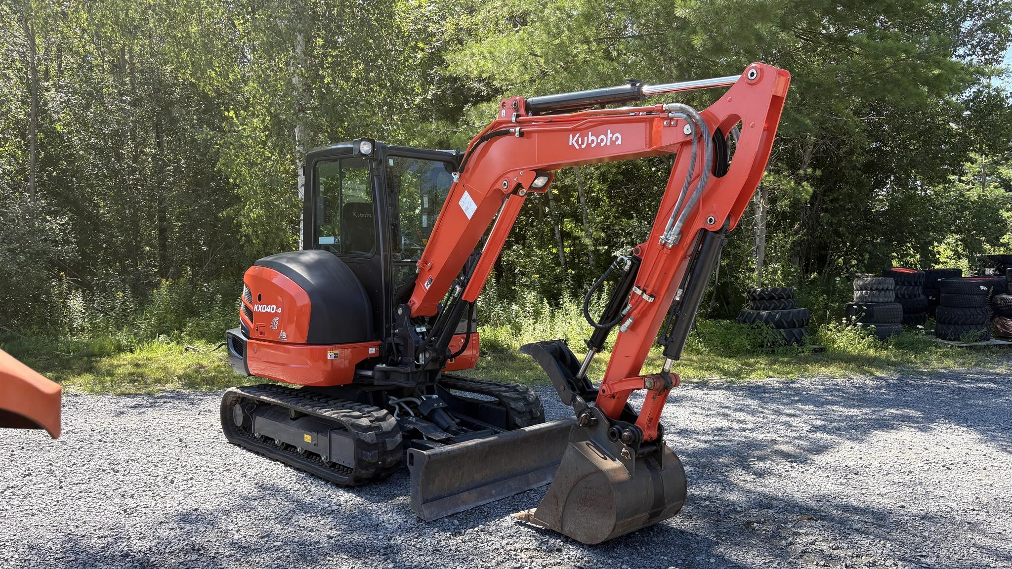 2024 Kubota KX040-4 mini excavator parked outdoors.