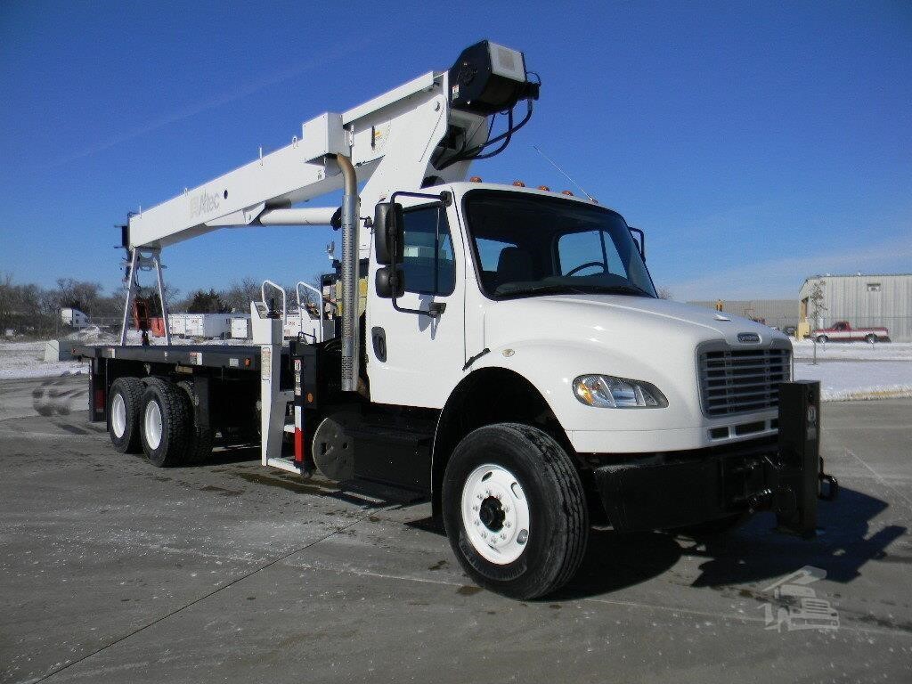 A 2016 Altec AC23-95B Mounted On 2016 Freightliner Business Class M2 106 Mounted Boom Truck Crane sits on a lot.