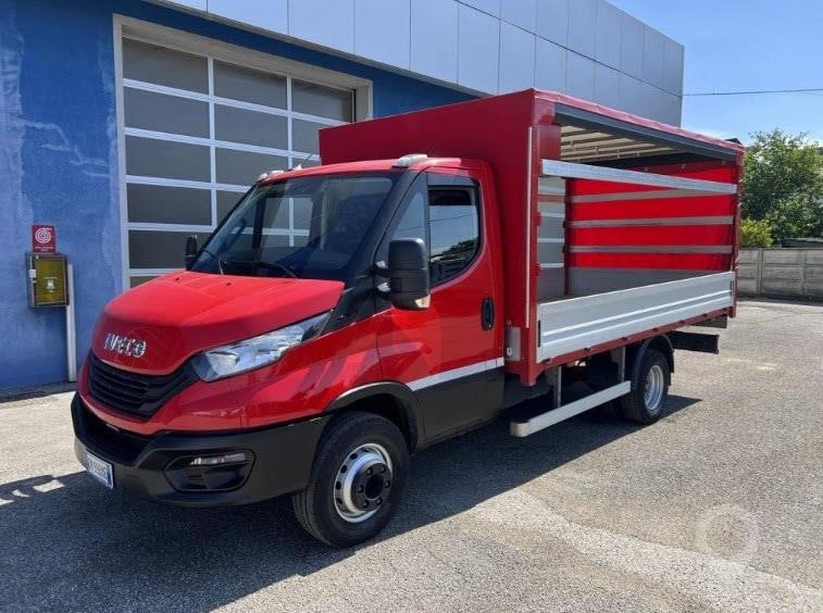 A 2023 Iveco Daily 72-180 curtainside van parked outdoors.