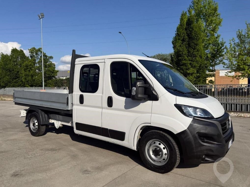A 2023 Fiat Ducato Maxi dropside flatbed van parked outdoors.