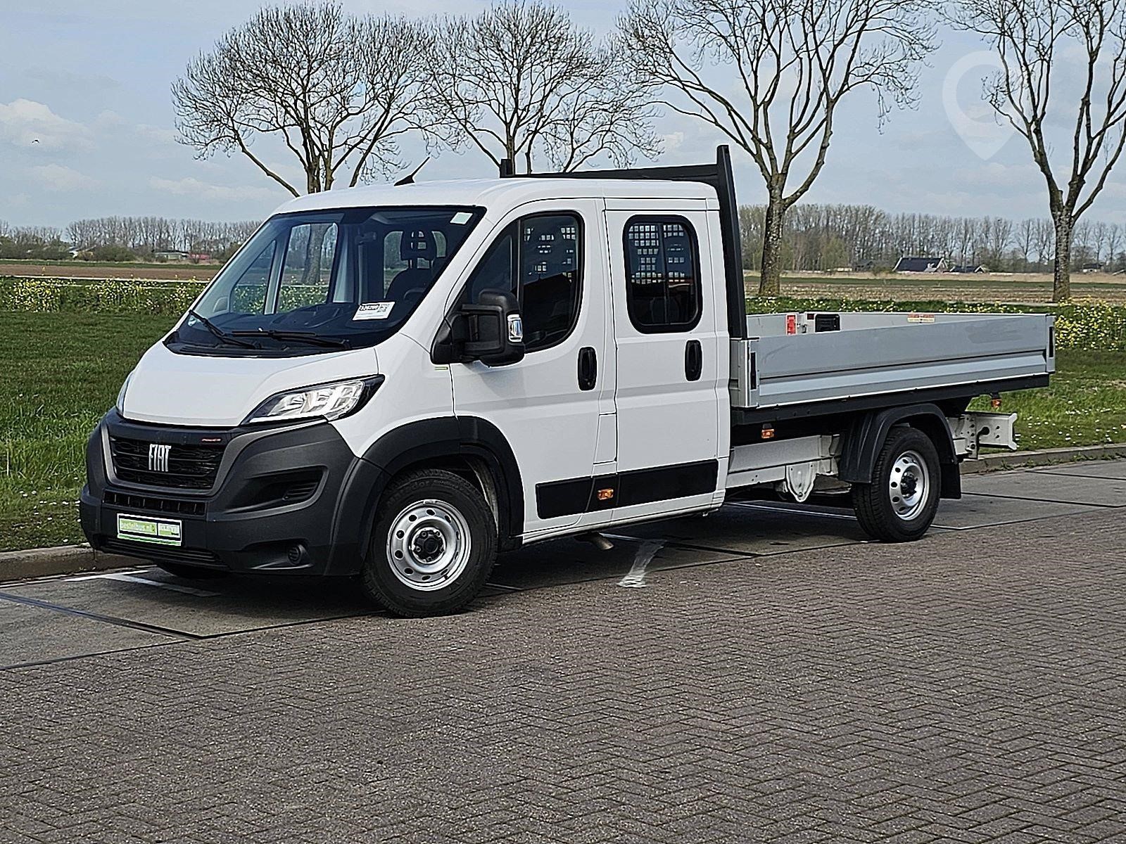 A 2023 Fiat Ducato standard flatbed van sits on a lot.