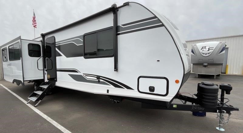 A 2025 Crossroads Sunset Trail Super Lite 330SI Travel Trailer sits on a lot.