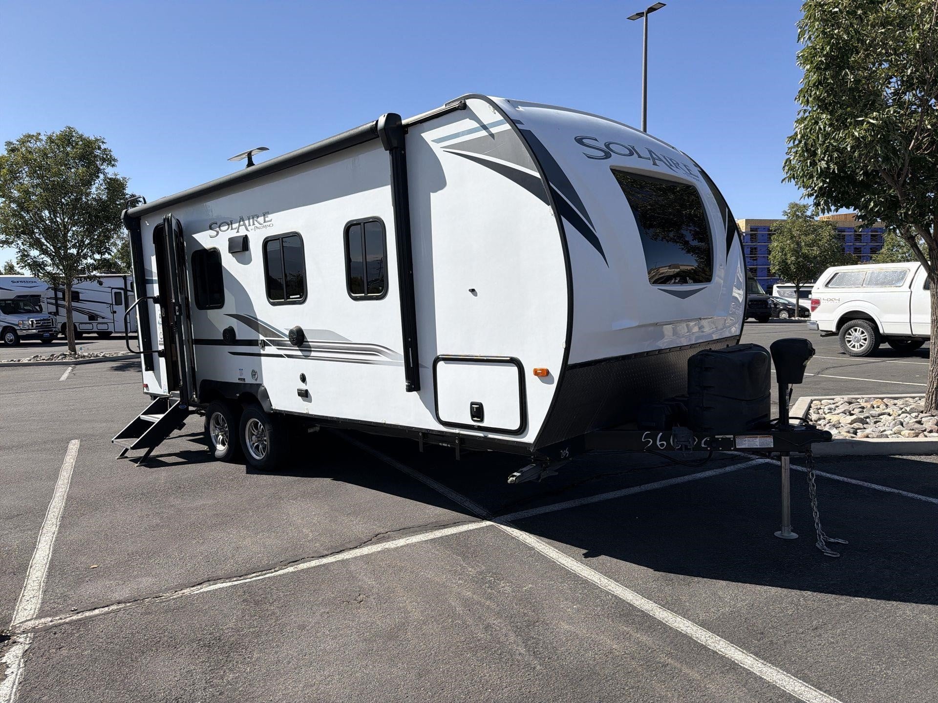 2021 Palomino Solaire 205SS travel trailer parked in a paved lot.