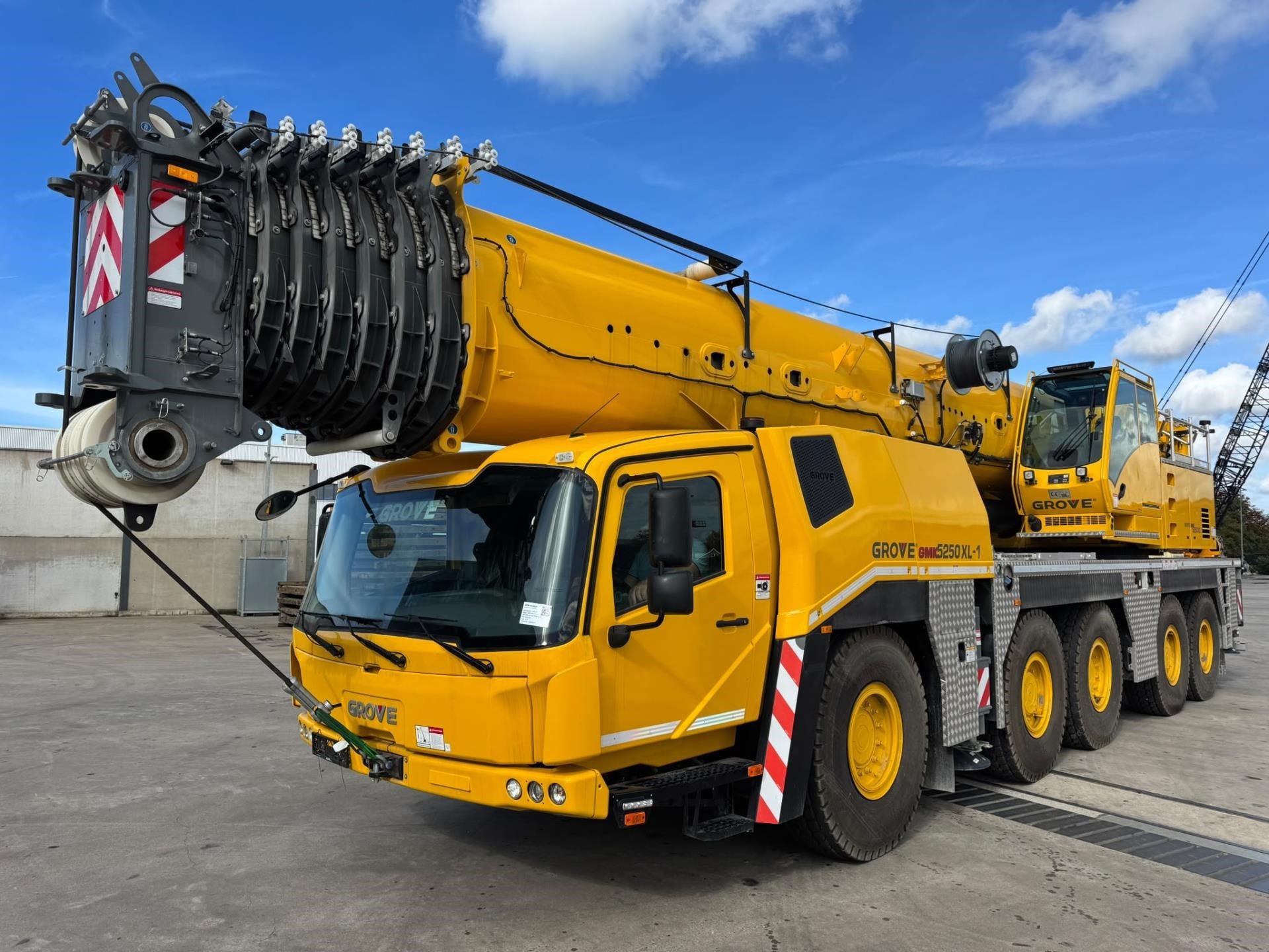 A 2024 Grove GMK5250XL-1 all-terrain crane sits on a lot.