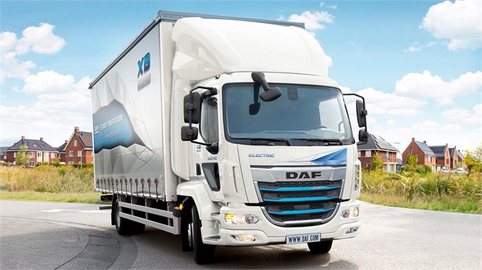  A Daf New Generation XB Electric truck sits on a road with houses in the background.