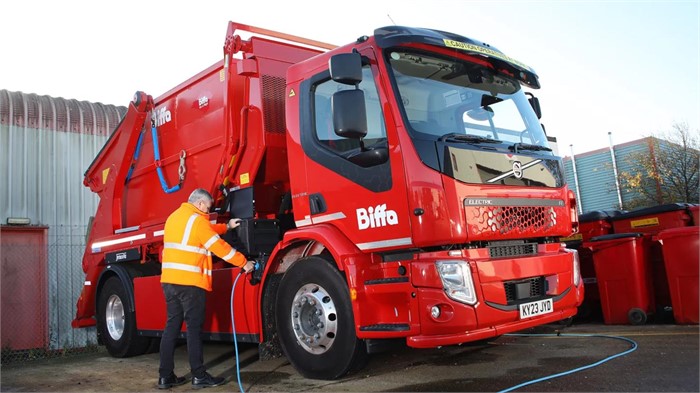 A Volvo FE Electric’s operator plugs in the truck following a shift to recharge it.