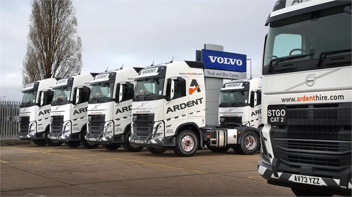 A fleet of Volvo FH 500 6x2 tractor units sits in a parking lot.