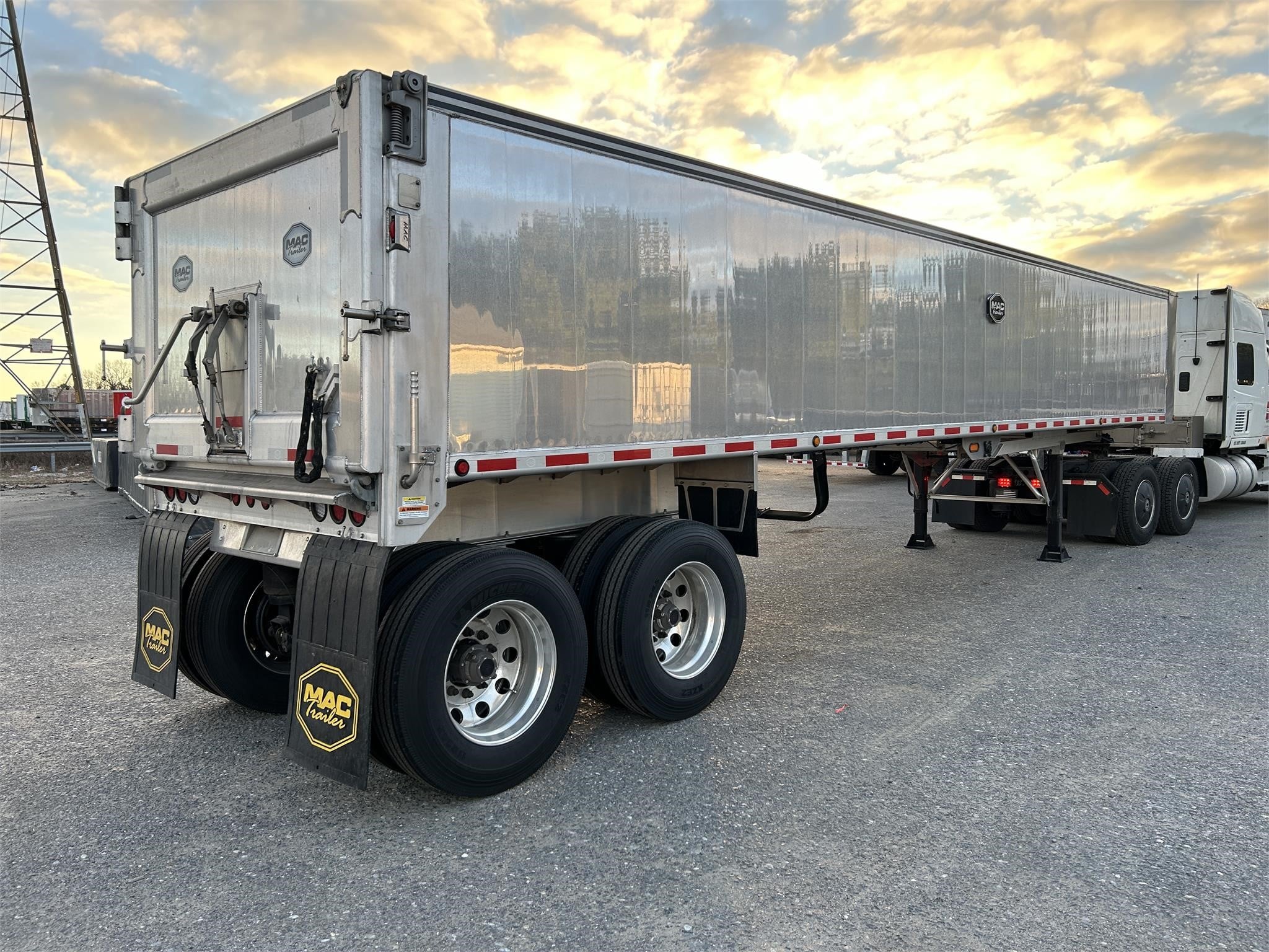 A 2024 MAC Trailer Mfg end dump trailer parked outdoors.
