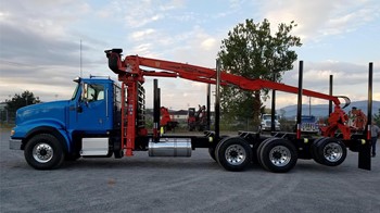 A 2023 Serco 8500 truck-mounted log loader parked in a lot.