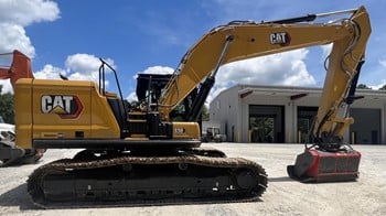 A 2022 Caterpillar 330 excavator mulcher in a lot.