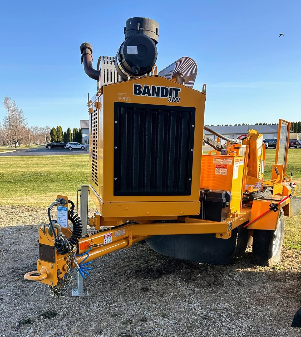 A 2024 Bandit 3100 towable stump grinder sits in a yard.